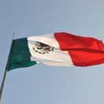 Mexico’s flag flies on a flagpole.