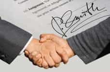 Two hands shaking one another in agreement.