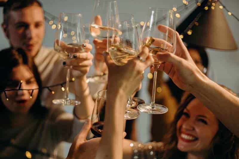 A group of adults celebrating with glasses of champagne.