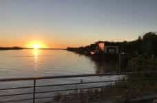The sun sets over the water in Paraguay.