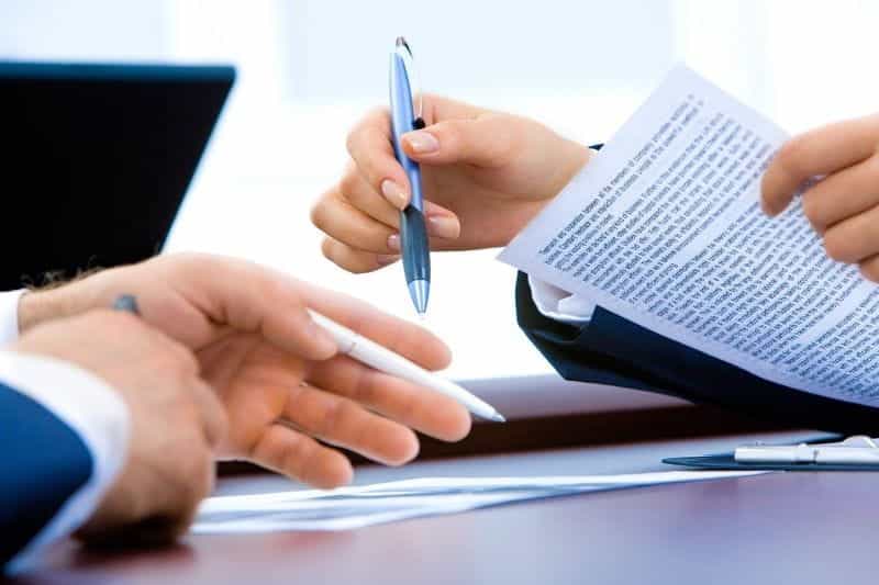 Lawyers exchanging contracts.