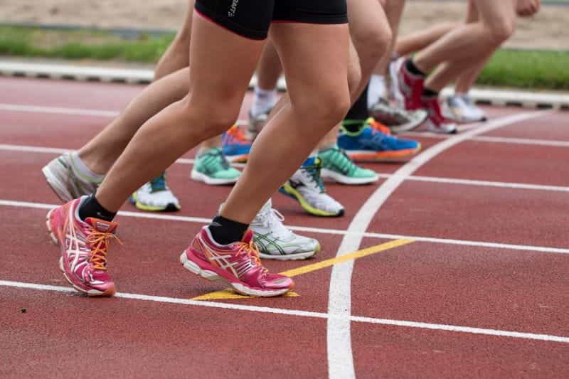 Athletes' feet at the start line of a race.
