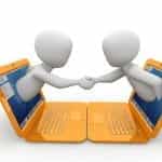 Two human models coming out of laptop screens facing each other and shaking hands.
