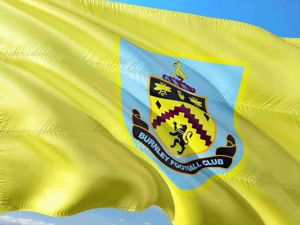 A yellow flag with the crest for Burnley Football Club.