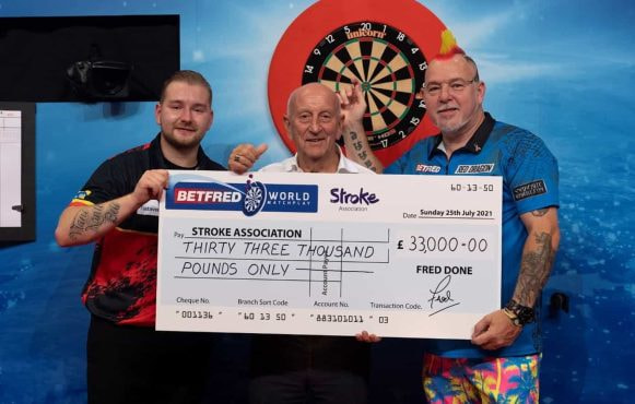 Dimitri Van den Bergh, Fred Done and Peter Wight holding a £33,000 charity check.
