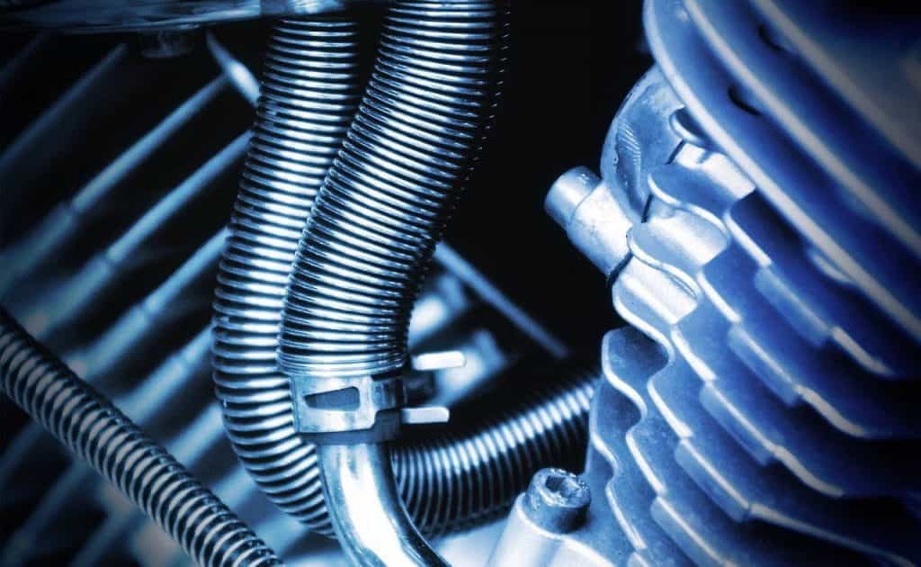 A zoomed in view of the gears and inner workings of a motorcycle.