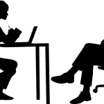 Two silhouetted figures having a meeting with one another at a desk.