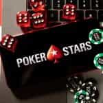 An iPhone displays PokerStars logo with chips and cards placed alongside it.