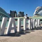 A large sign says VALENCIA in front of various tourist attractions.