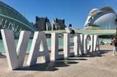 A large sign says VALENCIA in front of various tourist attractions.