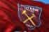A red flag with the West Ham United football club logo.
