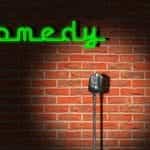 A standing microphone against the brick wall of a late-night comedy club.