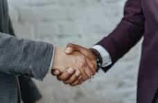 Two business people shake hands on a deal.