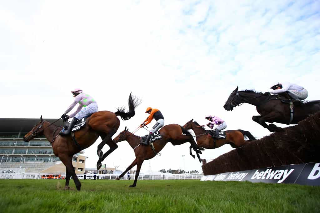 Horses jump the final fence in the Champion Chase at Cheltenham in 2021.