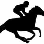 A silhouette outline of a jockey racing his horse during a race.