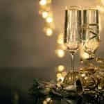 Champagne flutes with Christmas decorations.