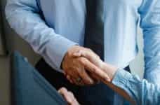 A businessman shaking hands with another person.
