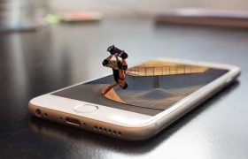 A skateboarder doing a trick while coming out of a smartphone screen.