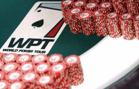 Chips neatly stacked on a WPT branded poker table..