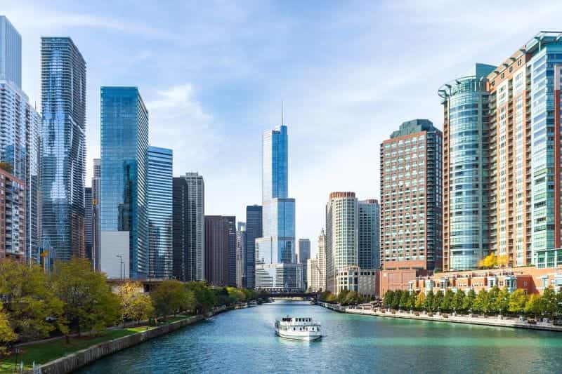 Downtown Chicago, Illinois, featuring a wide river surrounded by tall skyscrapers.