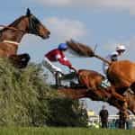 Grand National runners clearing one of Aintree’s famous obstacles.