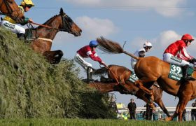 Grand National runners clearing one of Aintree’s famous obstacles.
