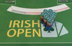 Cards and chips neatly prepared on an Irish Poker Open table.