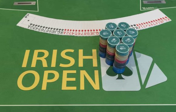 Cards and chips neatly prepared on an Irish Poker Open table.