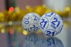 Two numbered bingo lottery balls.