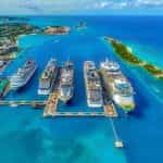 Alt Text: Aerial photo of cruise ships lined up in a port in the Bahamas.