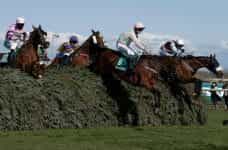 Horses clear a famous spruce fence during the 2019 Grand National.