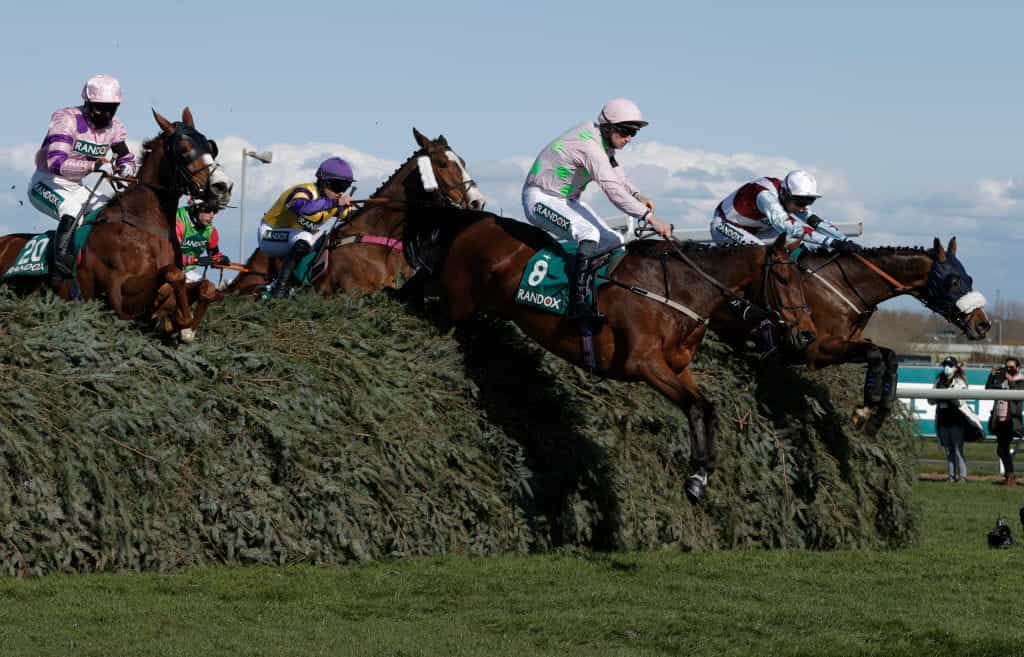 Horses clear a famous spruce fence during the 2019 Grand National.