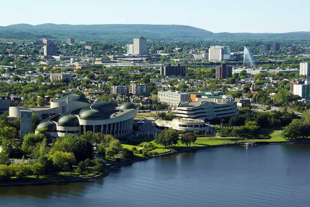 An aerial view overlooking Ottawa, Canada, featuring several distinct-looking buildings in the foreground.