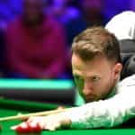 Judd Trump concentrating as he takes a shot.