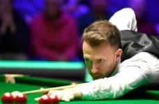 Judd Trump concentrating as he takes a shot.