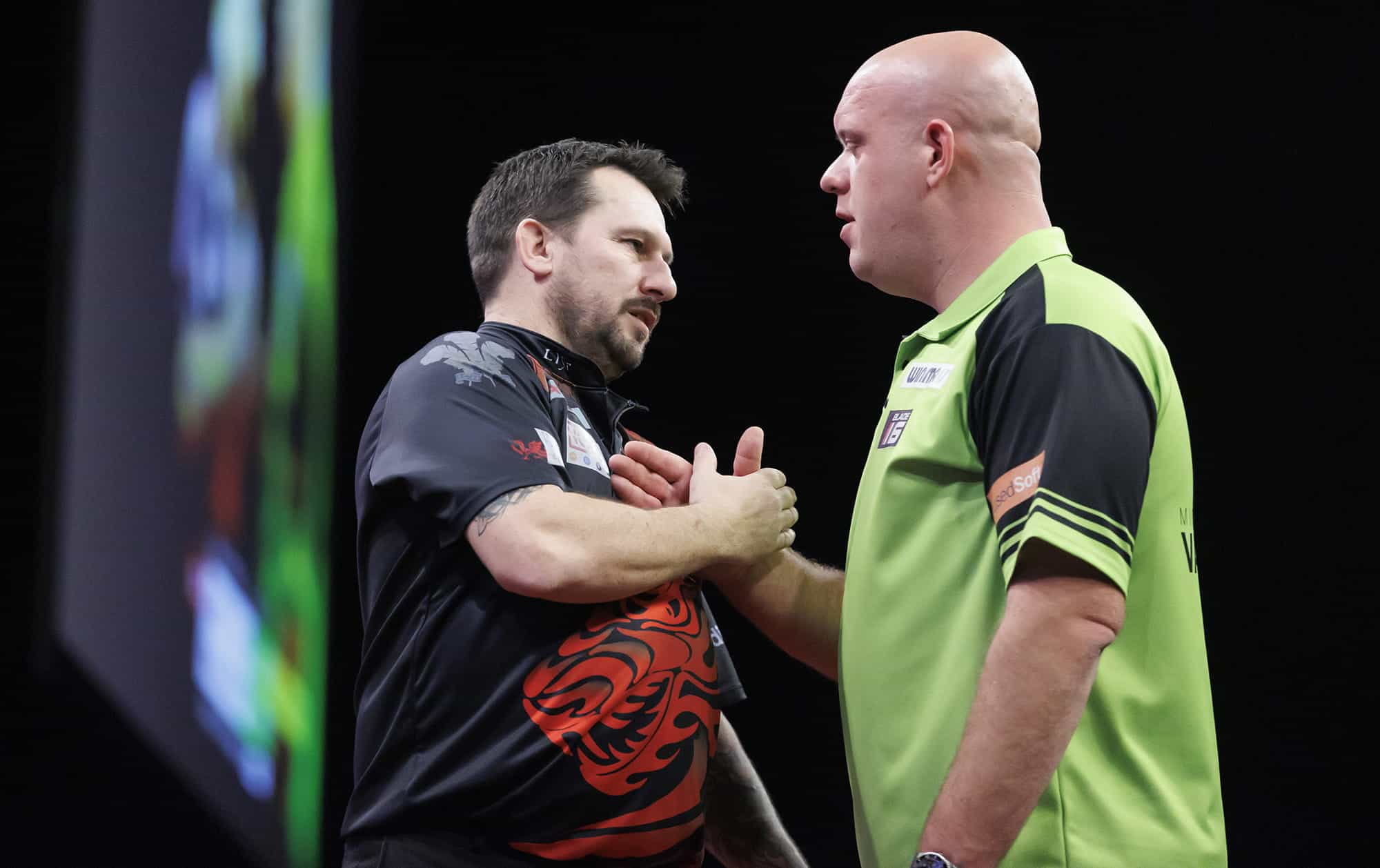 Michael van Gerwen and Jonny Clayton shaking hands after a Premier League encounter.