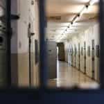 An empty prison through a locked door.