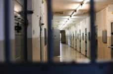 An empty prison through a locked door.