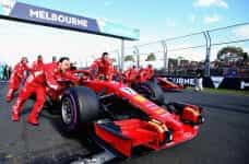 A red Ferrari Formula 1 car is pushed to the starting grid at the Australian Grand Prix.