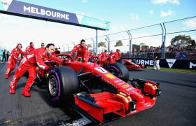 A red Ferrari Formula 1 car is pushed to the starting grid at the Australian Grand Prix.