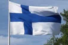 A Finnish Flag (white background with off-set blue cross) on a flagpole.