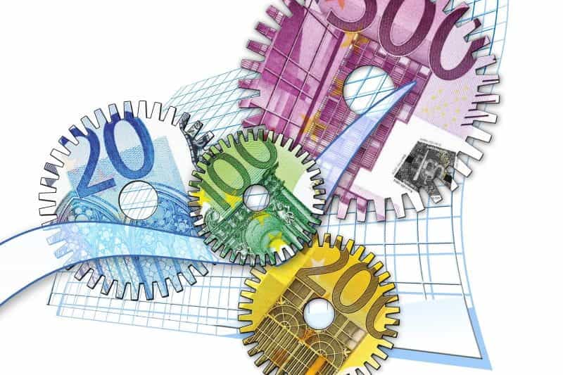 Interlocking gear cogs with different denominations of euro notes on them.
