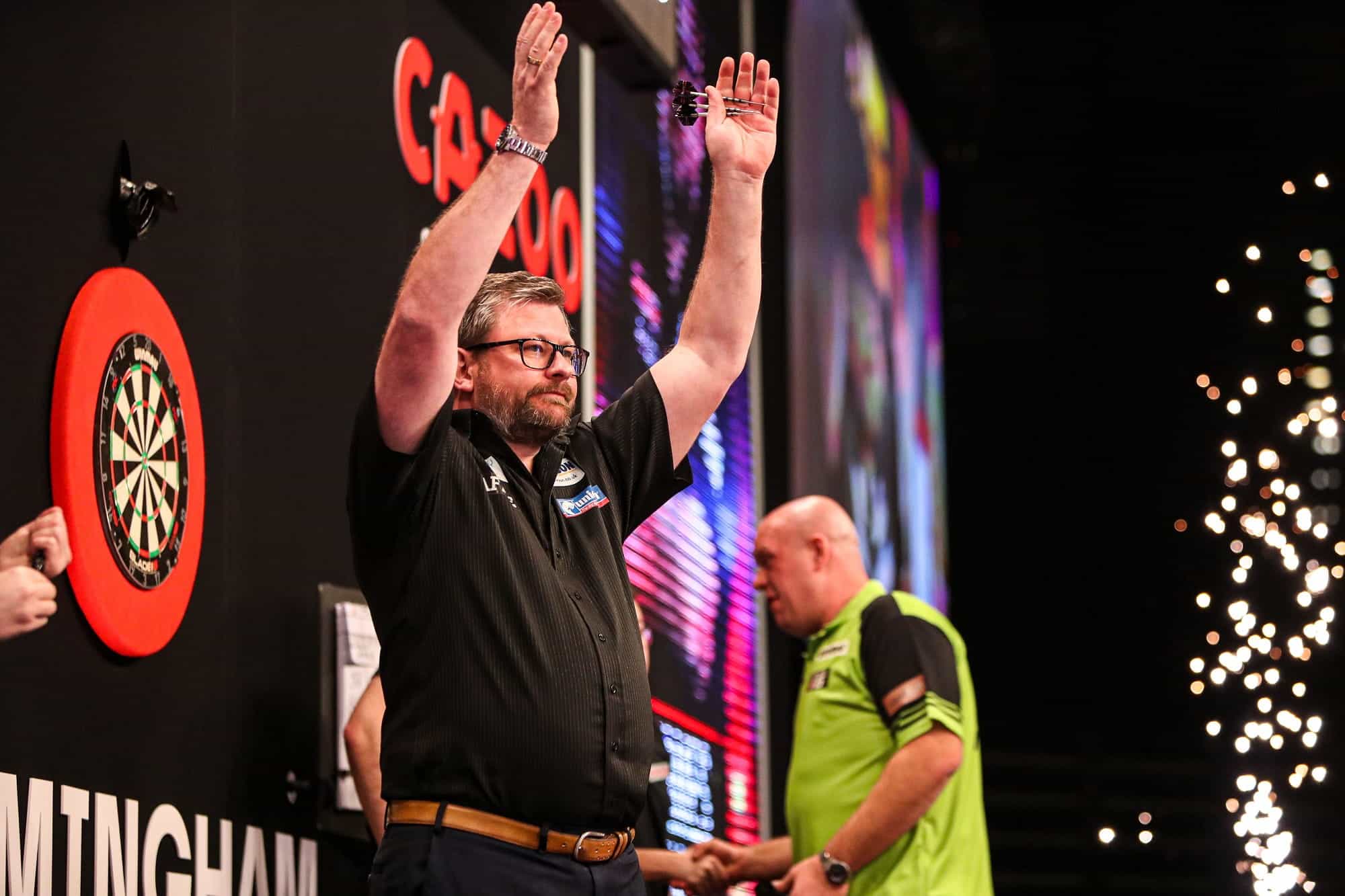 James Wade waves to the crowd after a Premier League victory over Michael van Gerwen.