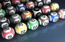 Colored lottery balls with numbers on lined up.