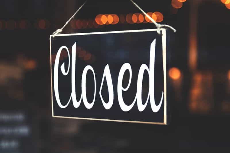 A black and white CLOSED sign hangs in a window.