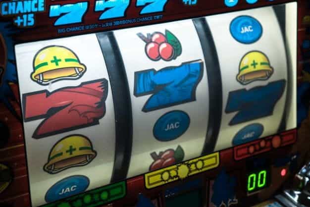 A slot machine screen shows a series of 7s and other symbols.