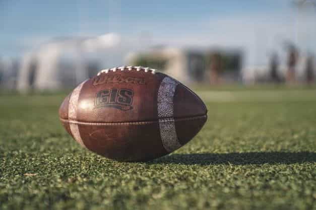 An American football on grass.