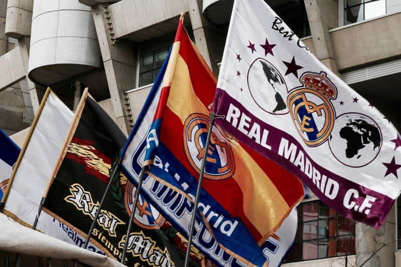 Real Madrid football club flags on a stadium.