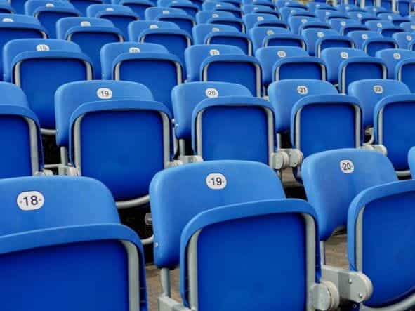 Blue chairs in a football stadium.