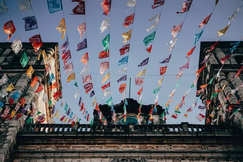 A temple in the Mexican city of Valladolid is decorated by many colorful flags.